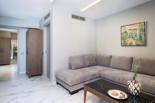 a living room with a couch and a table at Porto Platanias Beach Luxury Selection - Adults Only in Plataniás