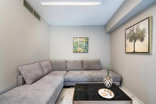 a living room with a couch and a table at Porto Platanias Beach Luxury Selection - Adults Only in Plataniás