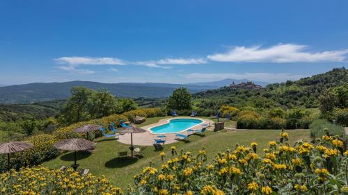 an estate with a swimming pool and a garden at PODERE SAN ANSANO 14&2, Emma Villas in Paganico