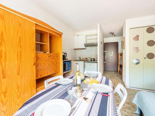 une salle à manger avec une table et des chaises et une cuisine dans l'établissement Studio La Frégate-12 by Interhome, au Grau-du-Roi