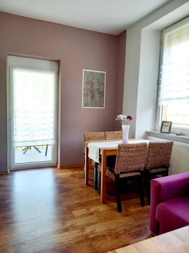 a living room with a dining room table and chairs at Ferienweingut Gansen / Hochgenuss 1 in Ernst