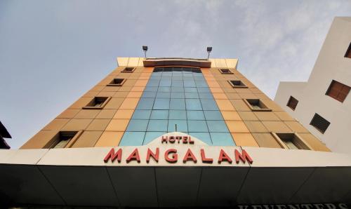 a korea marriott manhattan building with a sign on it at Treebo Trend Mangalam in Kolkata