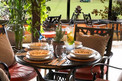 a table topped with plates of food and drinks at Green Garden Eco Resort & Villas in Playa de las Americas