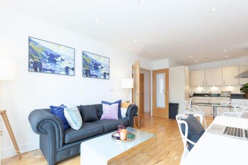 a living room with a couch and a table at Oxfordshire Living - The Tolkien Apartment - Oxford in Oxford