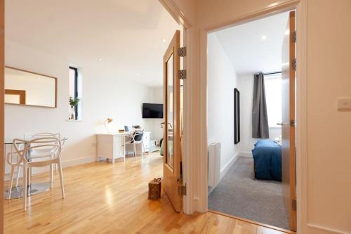 a living room with a table and a dining room at Oxfordshire Living - The Tolkien Apartment - Oxford in Oxford