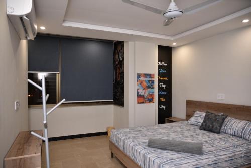 a bedroom with a bed and a black wall at The Bliss in Rawalpindi