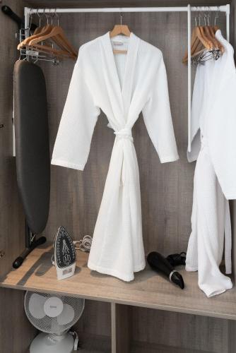 a white robe on a shelf in a closet at Best Western Carlton Hotel in Blackpool