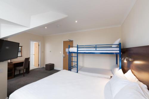 a bedroom with two bunk beds and a desk at Best Western Carlton Hotel in Blackpool