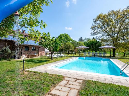 a swimming pool in the yard of a house at Holiday Home Cascina Anna by Interhome in Basaluzzo