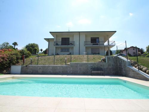 a villa with a swimming pool in front of a house at Holiday Home Antonia by Interhome in Porto Valtravaglia