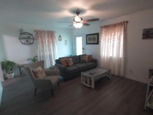 a living room with a couch and a table at Welcome to Pineapple House! in Pensacola