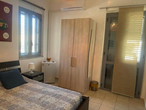 a bedroom with a large bed and a closet at Palazzo ReSilente- B&B dell'Infopoint in Castelnuovo Cilento