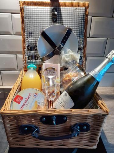 a basket with a bottle of wine and food at Orchard View Yurt & Hot Tub Somerset in Weston-super-Mare