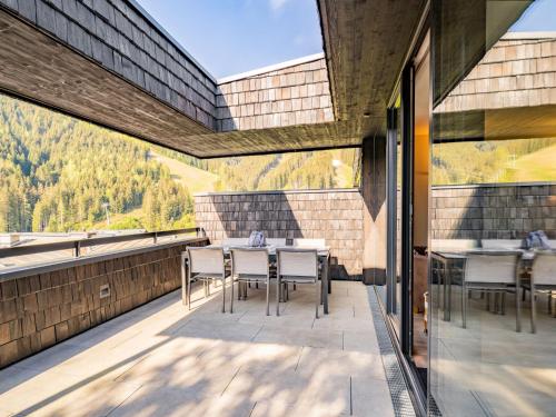 a patio with a table and chairs on a balcony at Apartment Sunny by Interhome in Zell am See