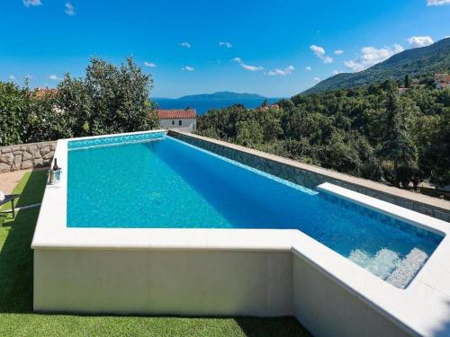 a swimming pool with a view of the mountains at Villa Vita,free wifi,nearby sea in Opatija