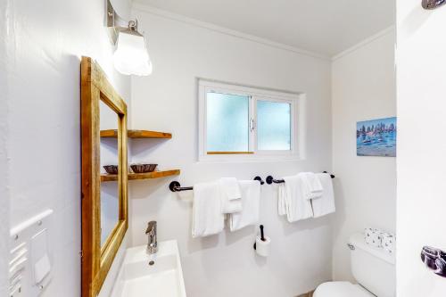 a white bathroom with a sink and a mirror at The Chalets at Kings Beach III in Kings Beach