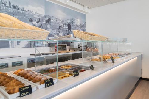 a bakery counter with various pastries and bread at Hotel Imperiale in Cattolica
