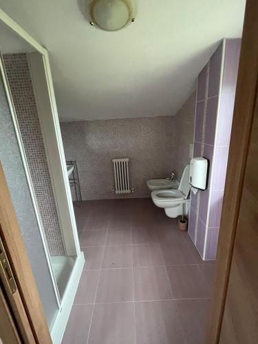 an empty bathroom with two toilets and a sink at Casa dello Yoga Suite e Private Spa in Colonnella