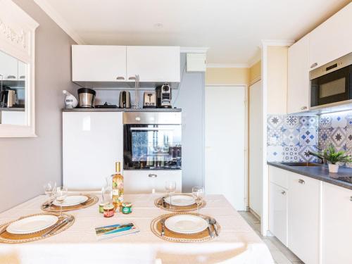 une cuisine avec une table avec des assiettes dessus dans l'établissement Studio Le Hameau - L1 310 by Interhome, à Agay