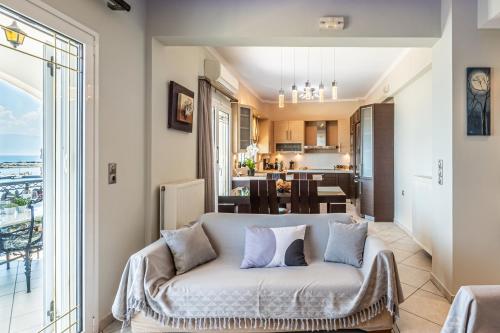 a living room with a couch and a view of the ocean at Bay View House in Petalidi