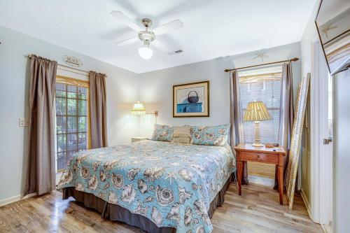 a bedroom with a bed and a table and a window at Geechee Girl in Edisto Beach