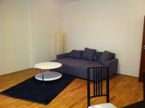 a living room with a couch and a table at Appartment München Isartor in Munich