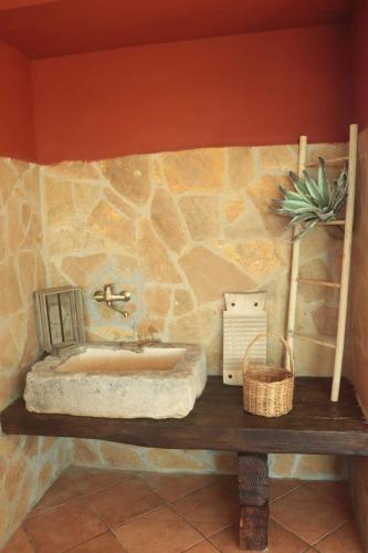 a stone bathroom with a sink on a table at Villa Rosalba in Polignano a Mare