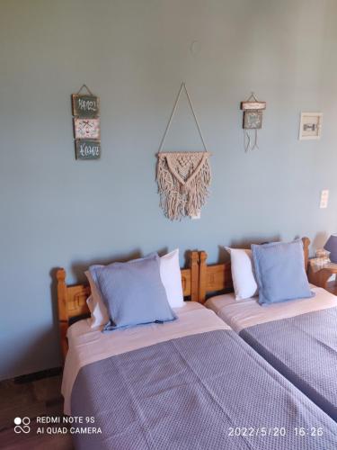 two beds sitting next to each other in a room at Studios Maro in Skala Kallonis
