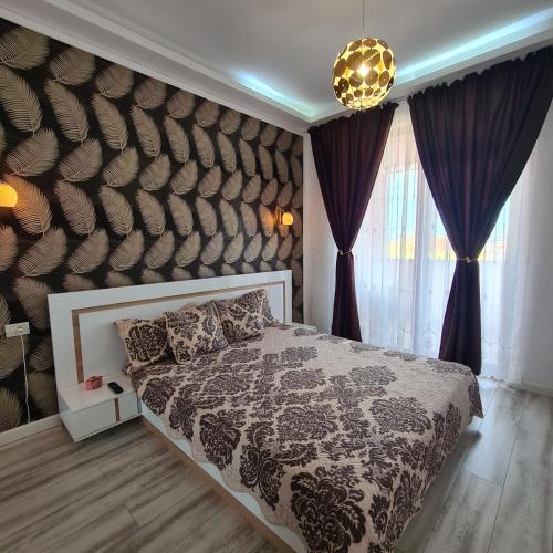 a bedroom with a large bed with purple curtains at Ella Luxury Apartament in Năvodari