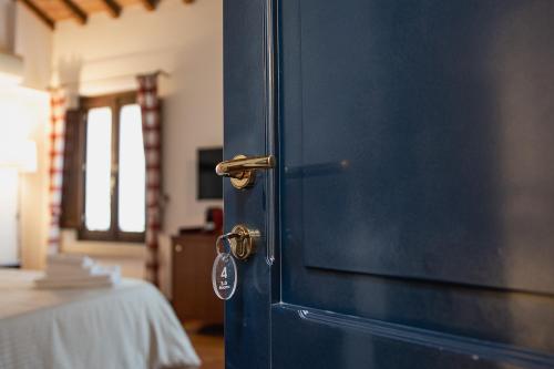 a blue door with a key in a room at Boutique Rooms 3 0 in Ferrara