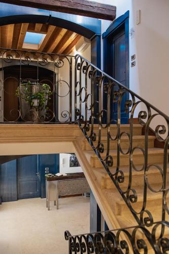 a stairway with a railing with plants on it at Boutique Rooms 3 0 in Ferrara