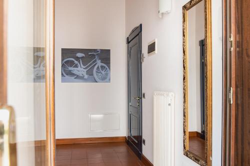 a hallway with a mirror and a bike on the wall at Boutique Rooms 3 0 in Ferrara