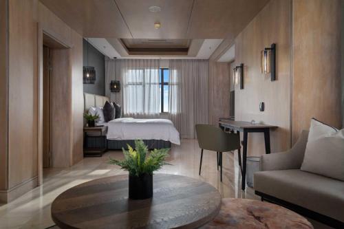 a hotel room with a bed and a table and a couch at The Capital Zimbali in Ballito