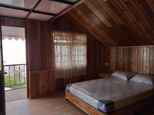 a bedroom with a bed in a wooden room at Sherpa Villa in Gangtok