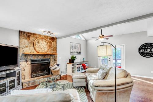 a living room with a couch and a fireplace at Morning Mist Lake House in Lithonia