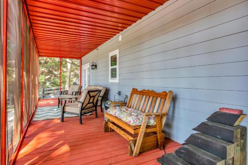 a porch with a bench and a table and chairs at Morning Mist Lake House in Lithonia