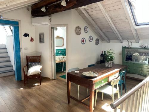 a dining room with a table and chairs in a room at donna serena Aci Castello in Aci Castello