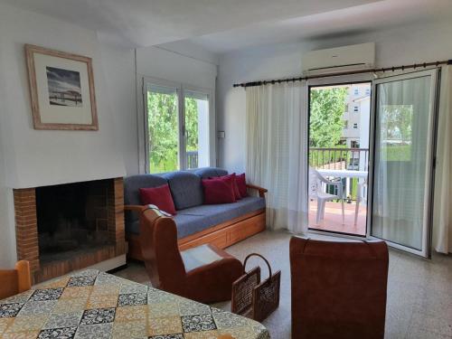 a living room with a couch and a fireplace at Holiday Home Villa Guapa in L'Estartit