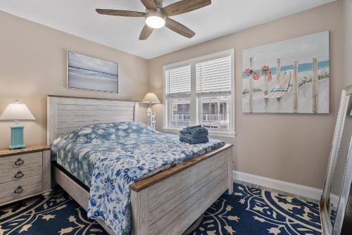a bedroom with a bed and a ceiling fan at Beach Block Parking Deck in Brigantine