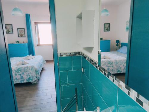 a bathroom with two beds and a mirror at Sisinedda in Siniscola