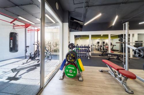 a gym with cardio equipment and a large window at Barceló Conil Playa - Adults Recommended in Conil de la Frontera