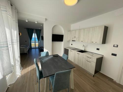 a kitchen and dining room with a table and chairs at Levante in Trani