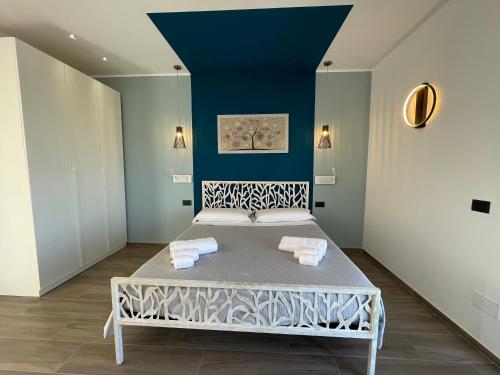 a bed in a room with a blue wall at Levante in Trani