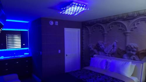 a room with a bed with a purple lighting at Americas Best Value Inn Providence-North Scituate in North Scituate