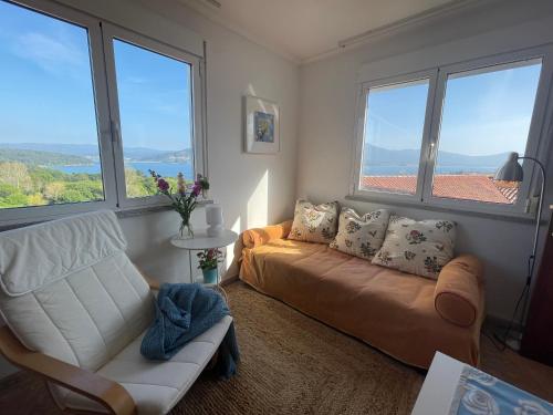 a living room with a couch and large windows at Fairview in Sabardes