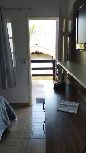 a kitchen with a counter and a view of a door at Pousada das Seriemas in Pirenópolis
