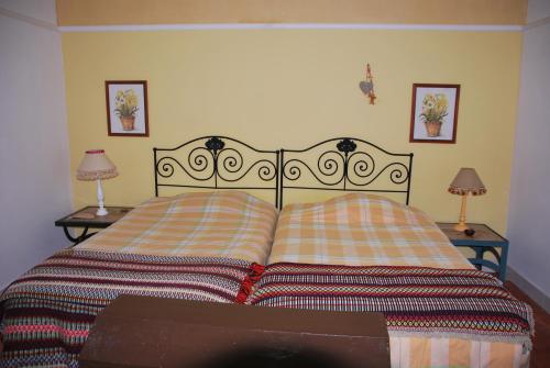 a bed with two pillows on it with two lamps at Monte Ramos in Ferreira do Alentejo