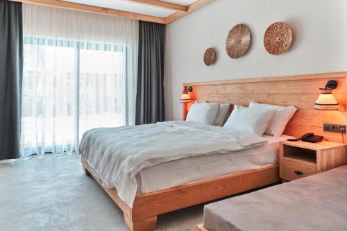 a bedroom with a large bed and a large window at The Pearl Ölüdeniz in Oludeniz