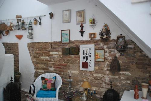 a room with a chair and a brick wall at Monte Ramos in Ferreira do Alentejo