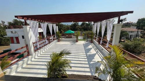 a covered walkway with a building with a roof at CASA DIOS Luxury Villas in Khandala